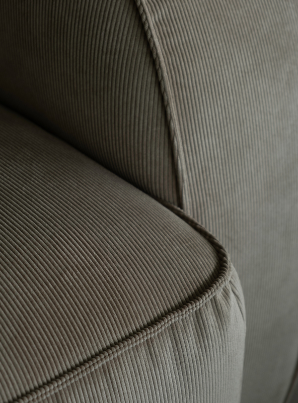 Close-up view of a ribbed, corduroy Sva module sofa corner with detailed stitching.