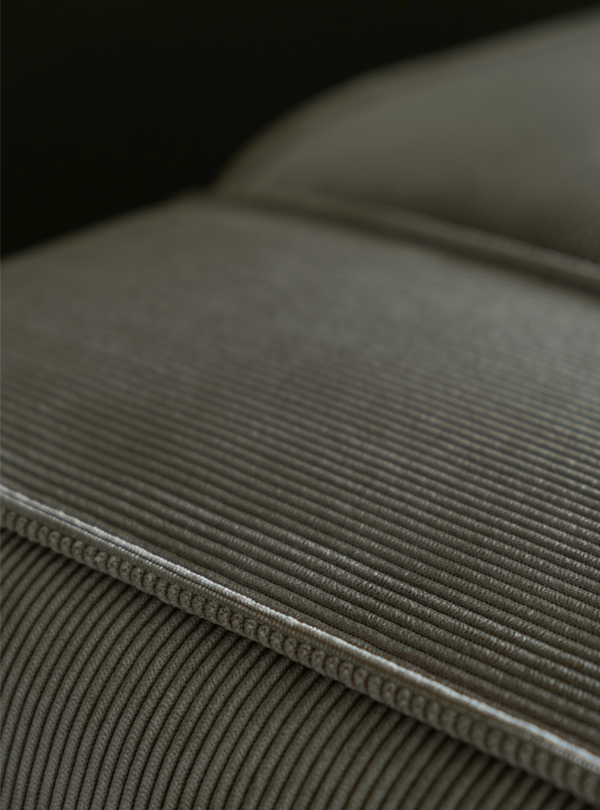 Close-up view of a ribbed, corduroy Sva module sofa corner with detailed stitching.