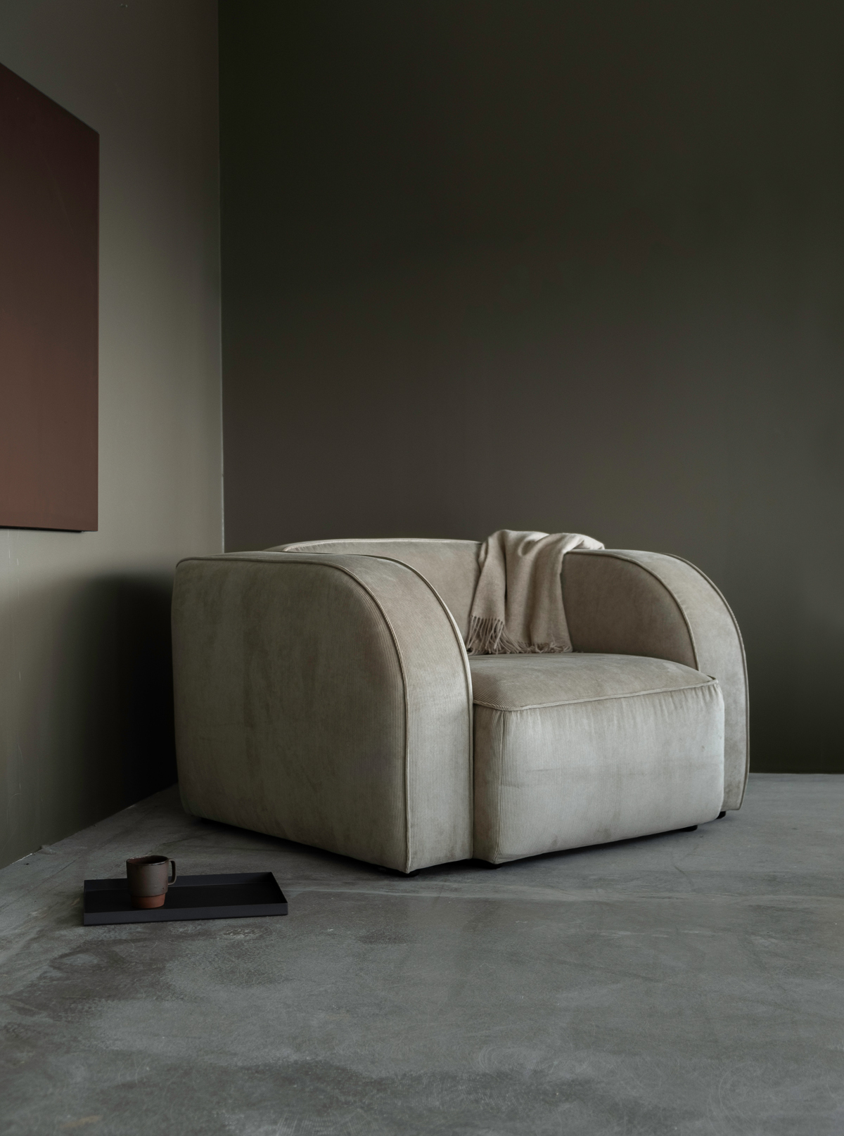 Minimalist living space featuring a plush, beige Sva module sofa with rounded edges and cozy ambiance.
